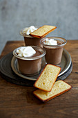 Small pots of chocolate cream dessert and Financiers