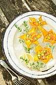 Salmon, mini courgette and mango tartare in courgette flowers