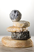 Various goat's milk cheeses stacked