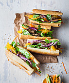 Baguette sandwiches with beef, oranges and salad
