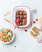 Various children's dishes (meatballs, sponge cake roll and bulgur salad)