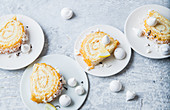 Parts of biscuit rolled with lemon and mini meringues