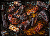 Grilled spare ribs on an oven tray (top view)
