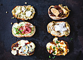 Toasted bread slices with various toppings