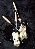 Cheese fondue: skewered bread cubes with cheese sauce