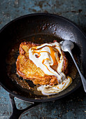 French toast with vanilla ice cream and toffee sauce in a pan