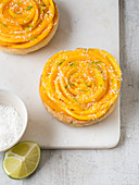 Lime and mango tartlets with grated coconut