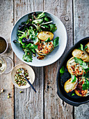 Potatoes stuffed with cream cheese and herbs, served with mixed salad with pistachios