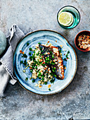 Grilled sea bass fillet with almonds and cauliflower with peas
