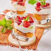 Summer tiramisu with raspberries and strawberries served in dessert glasses