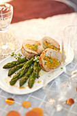 Roast turkey stuffed with onions served with green asparagus
