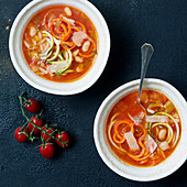 Tomato soup with vegetable spaghetti and white beans