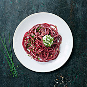Beetroot spaghetti with burrata wrapped in chives
