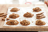 Muesli and spice biscuits on baking paper