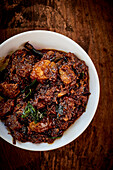 Two kinds of caramelised meat in a spicy basil sauce