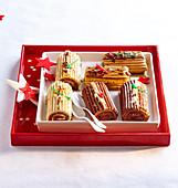 Vanilla, praline and chocolate Christmas mini log cakes