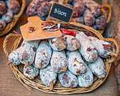 Stacked raw sausage at market stall