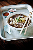 Soup with beef, meatballs and rice noodles