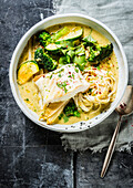 Cod in cream sauce with courgette, broccoli and linguine