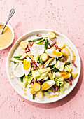 Liège salad with potatoes, egg, bacon, beans and goat's cheese