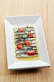 Anchovy fillets marinated in vinegar with tomatoes