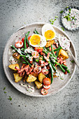 Salad with fried bacon, green beans and egg, baked potatoes