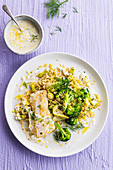 Fish fillet on rice with lemon, broccoli and leek