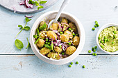 Baby potatoes with peas, pea hummus and mint