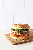 Veggie burger with cheddar cheese, tomato and lettuce
