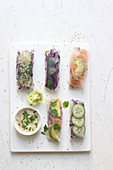 Summer rolls filled with various fillings and a dip