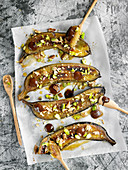 Baked bananas with chocolate, pistachios and nuts