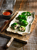 Rolled Swiss chard leaves stuffed with brown rice, tomato sauce