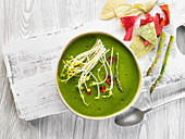Cream of green asparagus soup with chilli and sprouts