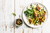 Grilled salad with figs, wheat, seed sauce and nuts