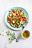 Wholemeal pasta salad with spring vegetables and mozzarella cheese