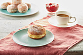 Doughnuts with jam filling with a cup of coffee
