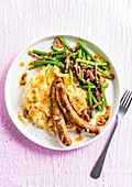 Chipolatas with potato and carrot puree and green beans with bacon