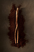 Cinnamon stick lying on ground coffee