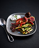 Appetizer plate with grilled courgette, peppers, onions and figs