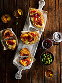 Spreads of melted cheese, tomato sauce and red fruit jam