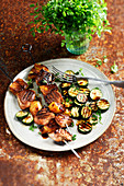 Pork and pineapple brochettes marinated in honey and soya,grilled courgettes
