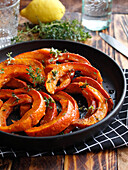 Roasted pumpkin slices with honey, thyme and lemon