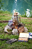Preparing coffee outdoors by the river