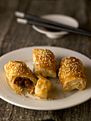 Stuffed puff pastry sesame rolls