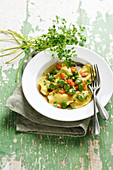Ricotta ravioli broth with broad beans and carrots