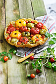 Caramelized multicolored tomato tart with thyme and balsamic vinegar