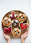 Mini pancakes with fruit spread and animal-shaped fruits
