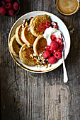 Oat pancakes with dried fruit,nuts and raspberries