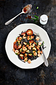 Squid ink spaghettis with shrimps,garlic and cherry tomatoes