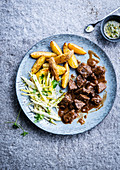 Beef stew with saut�ed potatoes and chicory